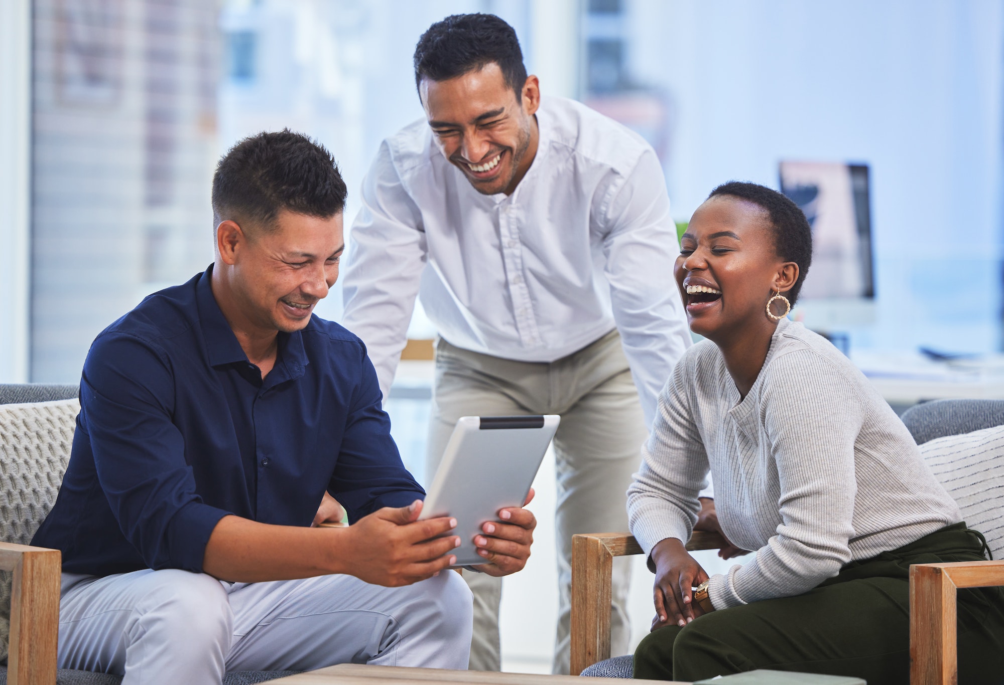 Shot of three businesspeople having a conversation in a modern office